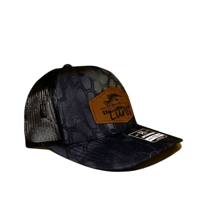 Right side view of the Thermocline Lures Kryptek Typhon/Black Trucker Hat, with a leather patch logo, black hexagonal camo front, and breathable black mesh back.
